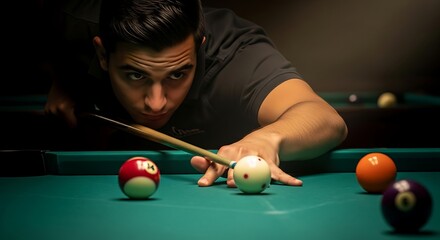 Intense focus: Young man aiming the cue ball for a precise billiards shot