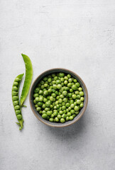Green pea in bowl on white background with copy space. Flat lay
