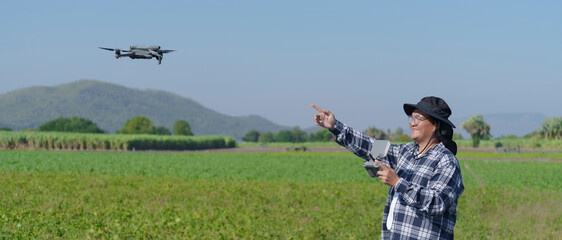 A male agronomist is using technology in a corn field. A corn farmer is examining his corn with a...