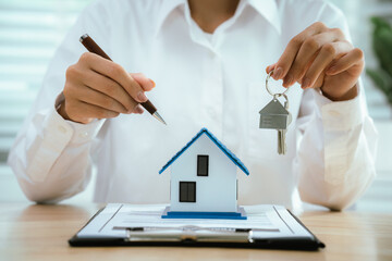 Real estate agents present home designs and discuss documents that reflect real estate investing,...
