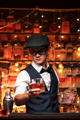 Bartender is pouring whiskey into a glass in a restaurant