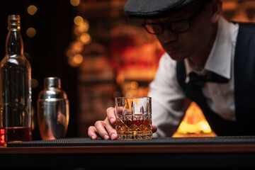 Bartender is pouring whiskey into a glass in a restaurant