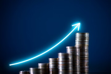 Investment growth financial success concept with coins and upward arrow on blue background