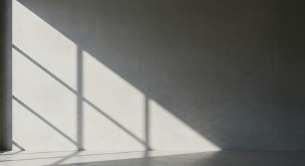 Obraz premium Abstract view of window light and shadow on a bare concrete wall. Serene minimalist interior background for contemplation.