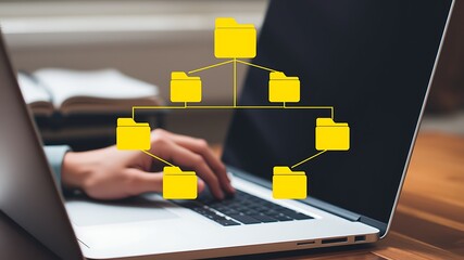 Person working on laptop with visual representation of a file management system folders network.