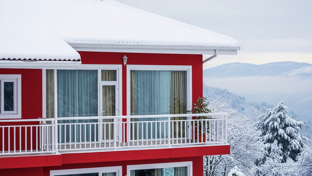 Red House with White Window and Snowy Roof – Cozy Winter Cabin in Nature

