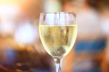 A glass of white wine on a blurred abstract background, alcohol, relaxation