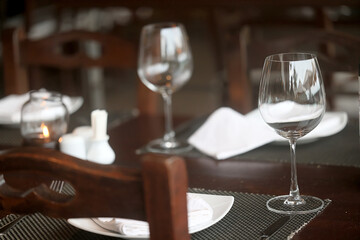 table setting in the restaurant, glasses and cutlery, a clean new table in the restaurant is waiting for guests, a free table