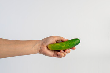 Fresh cucumbers and hand on white background.