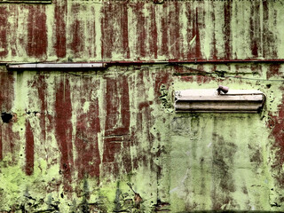 Green walls with messy brown red paint, dirty messy grungy surface texture.