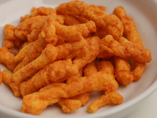 Crispy corn snacks on white plate