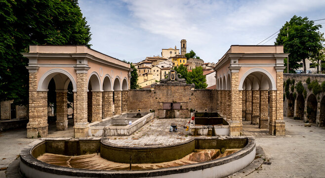 Historic Fountain Surrounded by Arches and Village View