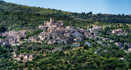 Naklejka premium Charming Hilltop Village Surrounded by Lush Greenery