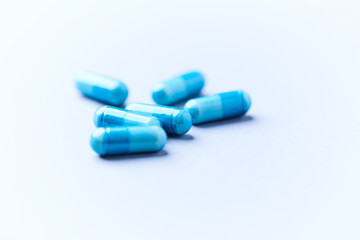 Amino acids capsules on bright background. Soft focus. Close up. Copy space.