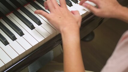 Close up of young child artist playing piano in a music record studio. 