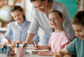 Happy kids and teacher at school