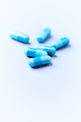 Amino acids capsules on bright background. Soft focus. Close up. Copy space.