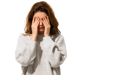 A young woman with hands over her face, expressing emotions of sadness or frustration, isolated on a white background.
