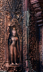 Fototapeta premium Intricate Stone Carving of Buddha Figure, in Angkor Wat, Cambodia