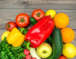 Assortment of fresh fruits and vegetables, top view on wooden background