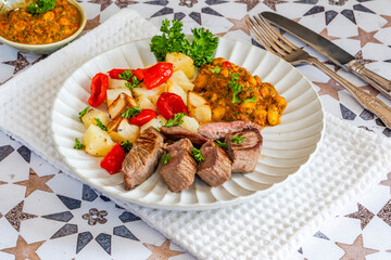 Lamb with smoky pepper sauce and saute potatoes