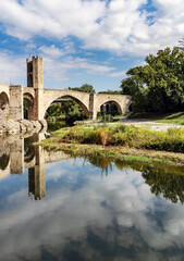Medieval Stone Bridge Reflecting in River, in Besalu, spain