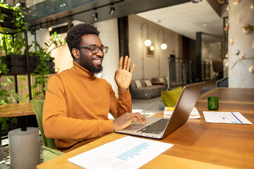 African American man smiling during video conference call from workspace