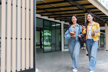 Two university students walking and talking on campus