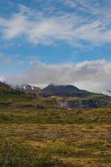 Rugged Icelandic Mountains with Snow Patches and Mossy Foreground