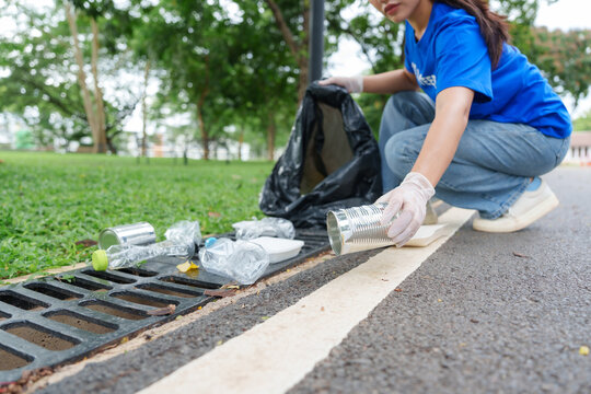 Volunteer picking up trash in public park