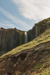 Icelandic Waterfall Cascading Over Basalt Columns with Clear Sky