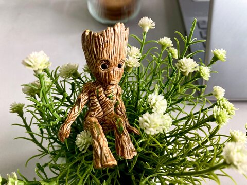 Groot character action figure on an artificial plant