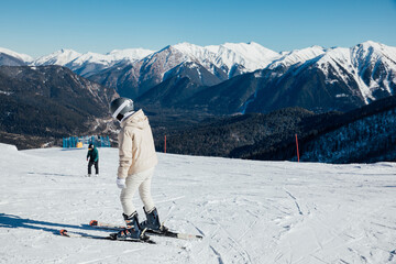 Skiers, snowboarders skiing in a mountain ski