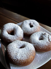 Donuts sprinkled with powdered sugar on top, 