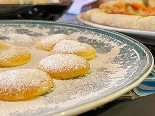 Dutch Mini Pancakes Poffertjes sprinkled with powdered sugar