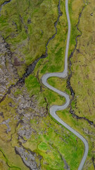 Winding road through the lush landscapes of the Faroe Islands captures natures serene beauty