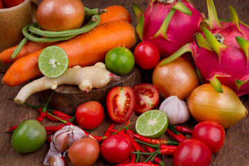 Mixed vegetables and fruits on old wood table background