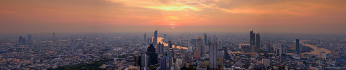 Fototapeta premium A bird 's eye view of Bangkok City Skyline at sunset. Panorama shot