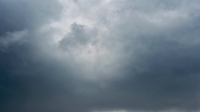 Dramatic timelapse of thick storm clouds rolling in, capturing the intense shift in weather and the dynamic movement of a moody sky.