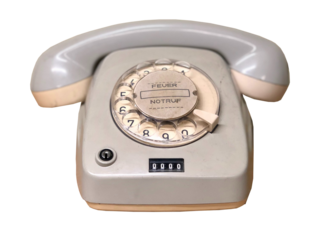 Vintage Telephone: A detailed shot of a classic telephone with a rotary dial and receiver, symbolizing communication, connectivity, and the technology of a bygone era.