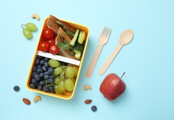 Healthy lunchbox with fruits on the table, promoting a balanced lifestyle. Top view, space for text