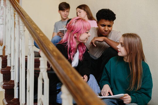 Diverse Group of Students Socializing on School Stairs While Sharing Ideas - Powered by Adobe