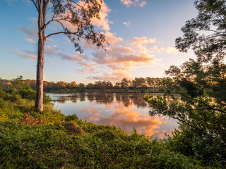 sunset over the river with cloud reflections