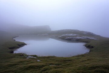 Misty mountain lake nestled in a valley