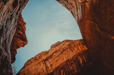 Artistic shot of the sky framed by towering sandstone mountains in Petra, Jordan, captured from a narrow canyon perspective
