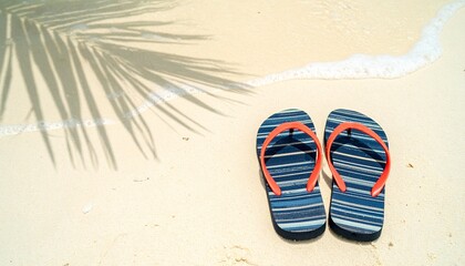 Fototapeta premium Blue flip-flops on tropical white sand beach with palm leaves overhead