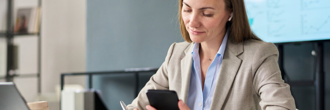 Business manager working with smartphone and report in modern office