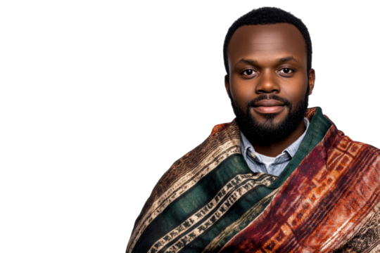 Man in traditional wrap standing confidently with a serious expression