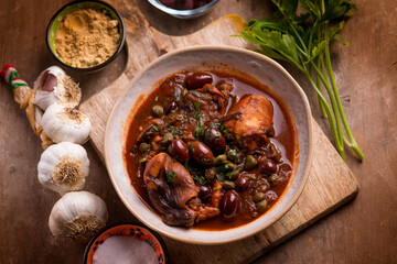 stewed polyps with tomato sauce black olives capers and parsley
