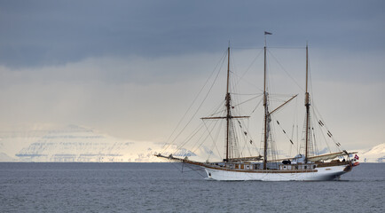 Beautiful vintage sailboat departing Longyearbyen in Svalbard, Norway